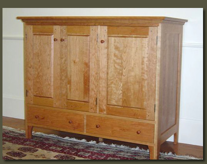 This lovely cherry entertainment center features clean, traditional lines and frame and panel construction