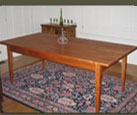 Our Cherry Dining Table has classic lines and a small drawer